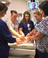 Nurses helping a baby